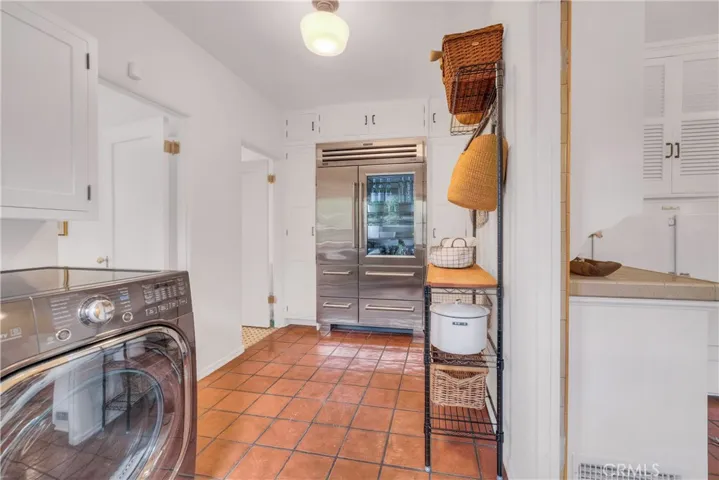Sub-zero fridge and washer and dryer area.