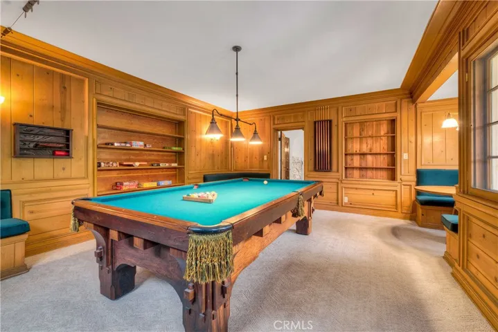 Game room with card table, built-in seats and refinished billiards table.