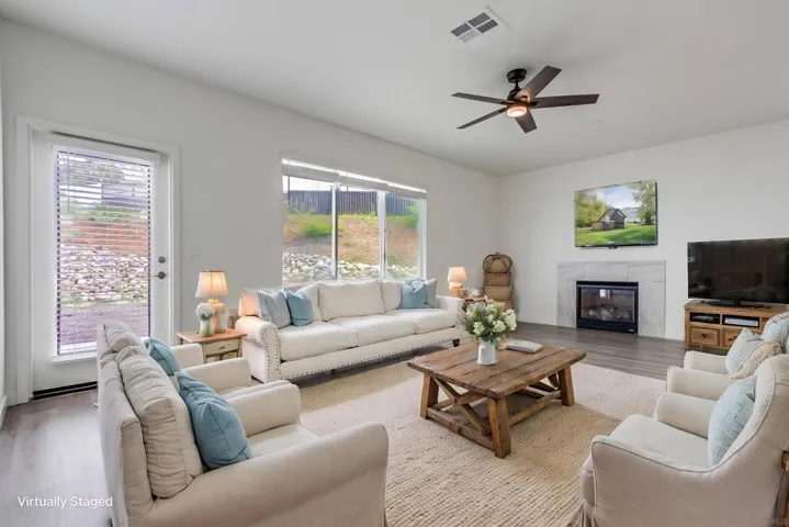 All pictures with furnishings are virtually staged simply to show what might be the new owners beautiful home.  This is a view of the living room with the fireplace.