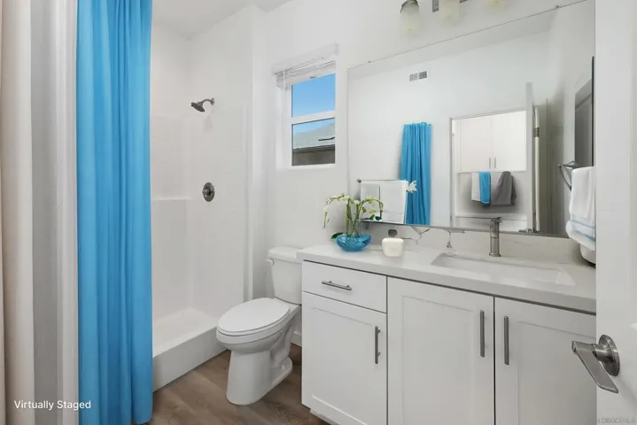 The bath for the downstairs primary.  All pictures with furnishings are virtually staged simply to show what might be the new owners beautiful home.