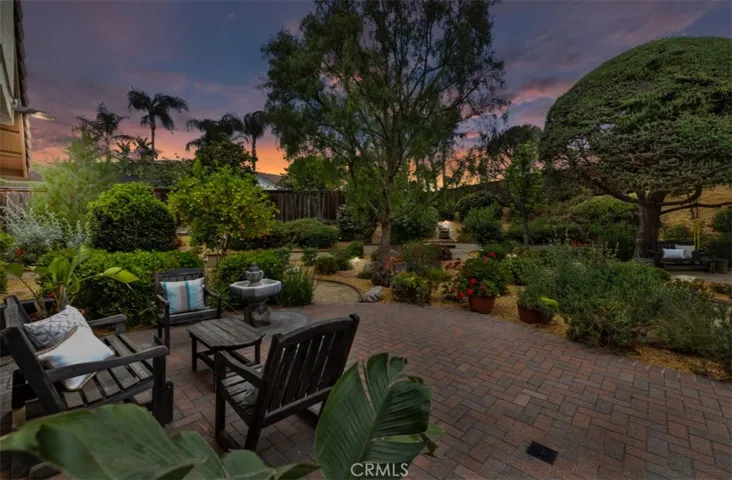 Private oasis where lush landscaping, a tranquil fountain, and cozy seating areas create a peaceful escape right in your own backyard.