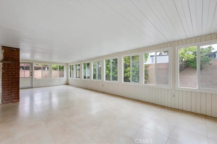 Tiled and covered Sunroom. Lots of light and windows!
