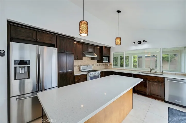 Kitchen with stainless appliances, island and lots of windows!