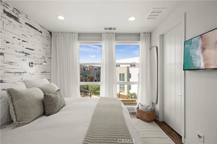 Primary Suite with floor to ceiling windows and custom walk-in closet