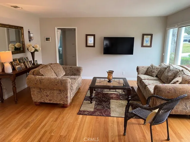 There are several ways to set up furniture in living room..We move small couch to face TV..Another way would be to put TV where mirror is and you could have big sectional in front of window and current tv wall