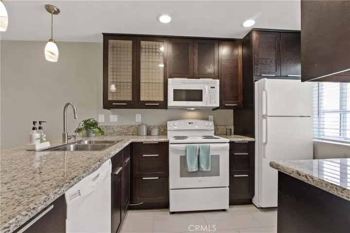Enjoy recessed lighting as well as fresh sunshine through the kitchen window.