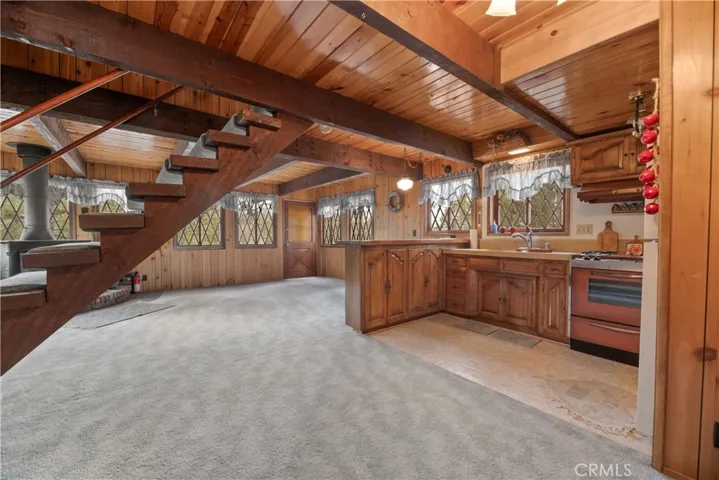 T & G Ceilings with Cross Beams. Downstairs they're flat, but upstairs they're vaulted.