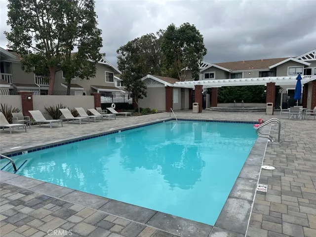 Community pool with lounge chairs and sitting area