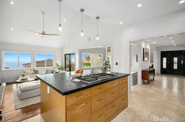 At the heart of the home, a beautifully designed chef’s kitchen boasts premium appliances—including a built-in Sub-Zero refrigerator and Bosch double oven and dishwasher—and enjoys scenic ocean views.