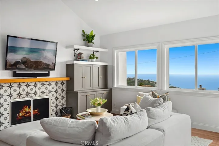 Perched on a generous corner lot at the end of a tranquil cul-de-sac, this home is thoughtfully positioned to capture stunning ocean, canyon, and city-light vistas.