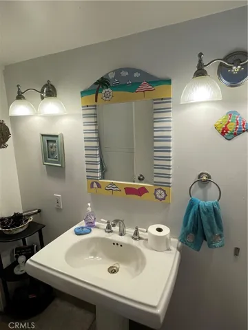Half bath with sink and toilet and exterior door
