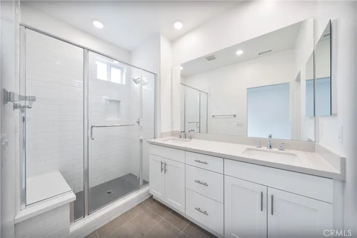 Upstairs Primary bathroom with dual sink, separate shower and toilet.