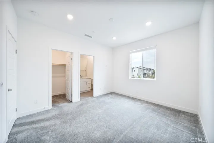 Upstairs secondary primary suite with walk in closet.