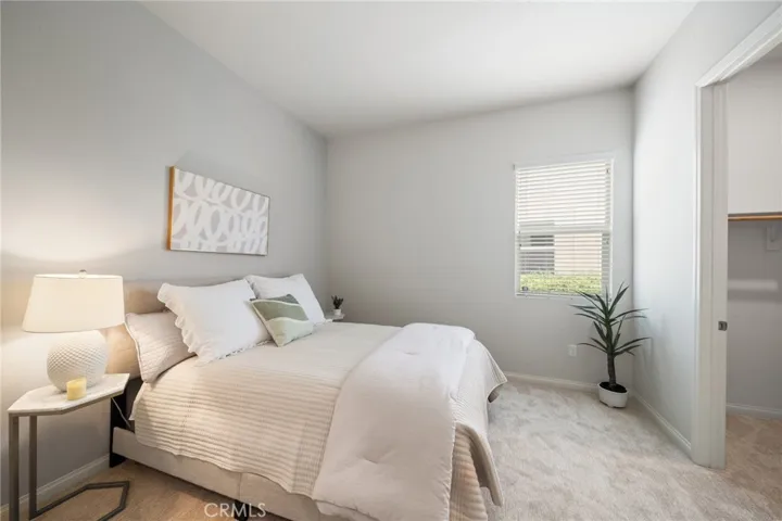 Tranquil Guest Bedroom with Plush Carpet and Walk-In Closet Access