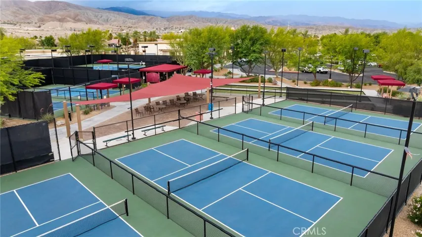 Expansive Pickleball Complex with Shaded Seating Areas and Stunning Mountain Backdrop, Perfect for Social and Competitive Play