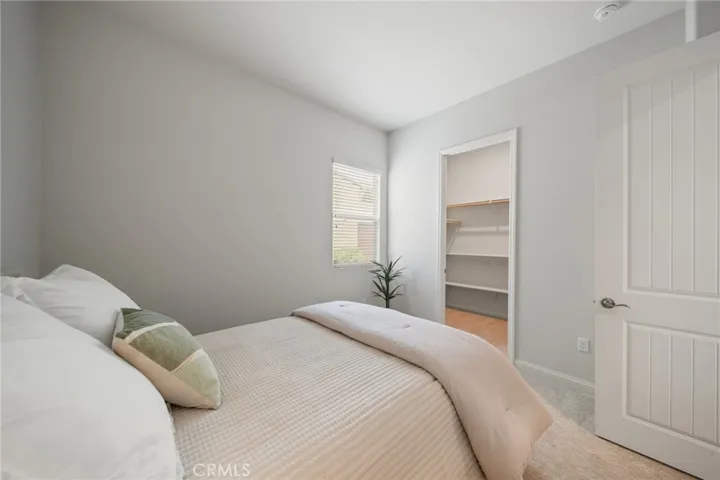 Bright Secondary Bedroom with Spacious Walk-In Closet and Serene View