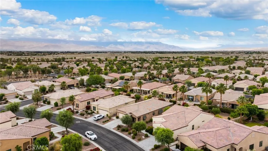 Beautiful Aerial View Showcasing a Peaceful Neighborhood with Lush Landscaping and Mountain Backdrop