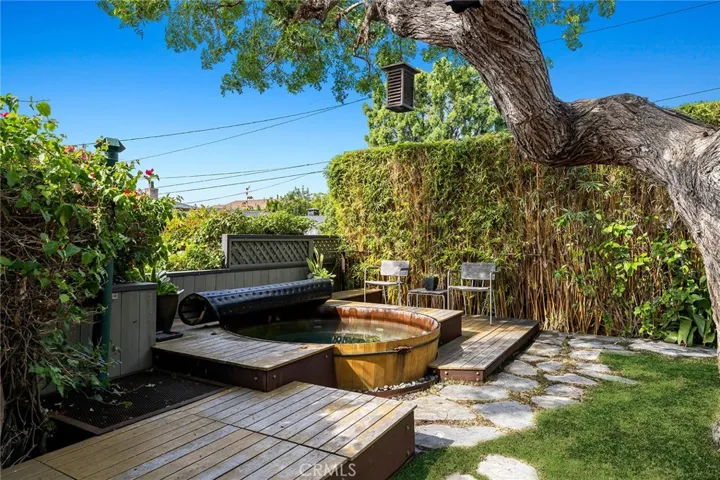 The gorgeous residence is embraced by serene zen-inspired gardens that feature majestic trees, manicured hedges, wood decks, a Japanese Soaking tub, stone pathways and an enchanting garden gate.