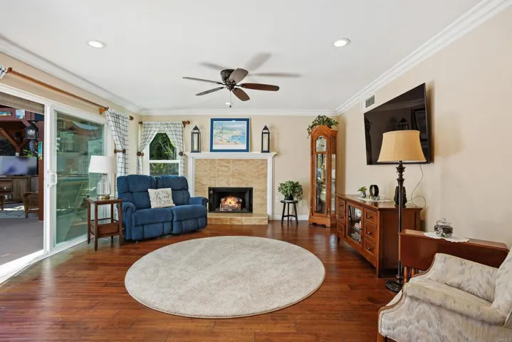 Living room with fireplace and sliding doors leading out to back patio and yard.