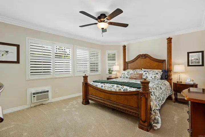 Primary bedroom with beautiful shutters.