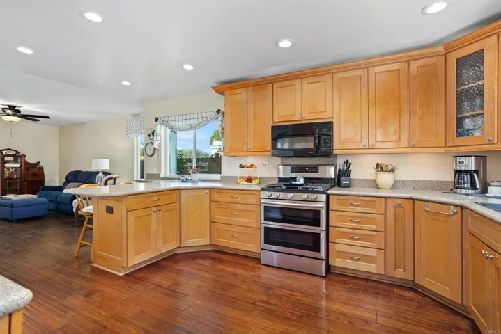 Double ovens, 5-burner gas stove, lots of counter space; opens to cozy family room.