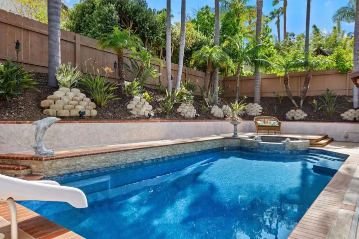 Sparkling pool with hot tub and slide!