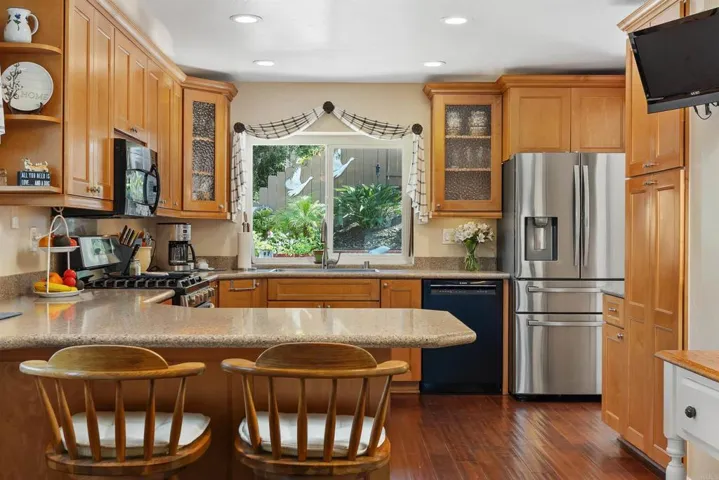 Double ovens, 5-burner gas stove, lots of counter space; opens to cozy family room.