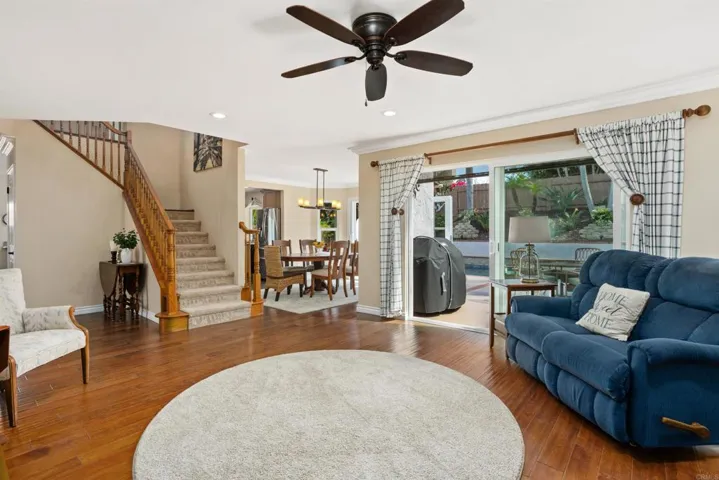 Living room with fireplace and sliding doors leading out to back patio and yard.