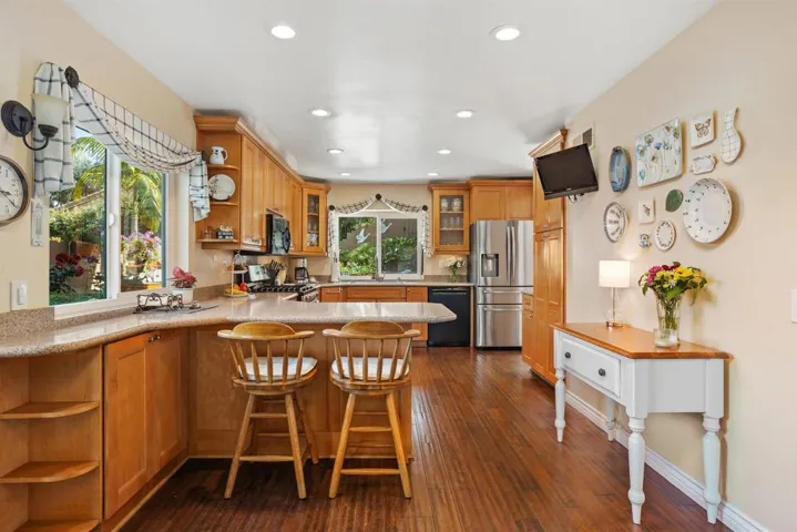 Double ovens, 5-burner gas stove, lots of counter space; opens to cozy family room.
