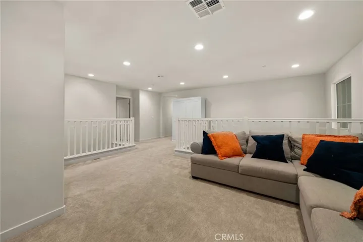 Loft with showing stairwell cathedral ceiling from first level