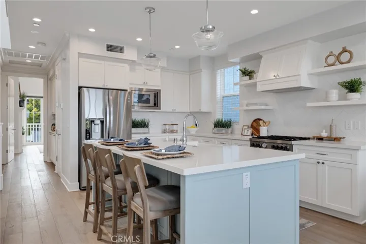 oversized island with bar seating and extra cabinets