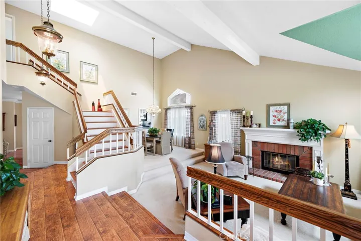 Formal entry. Open concept to living room and dining room featuring high ceilings and gas fireplace. Large windows lend to a light and bright Living room and dining with a skylight feature.