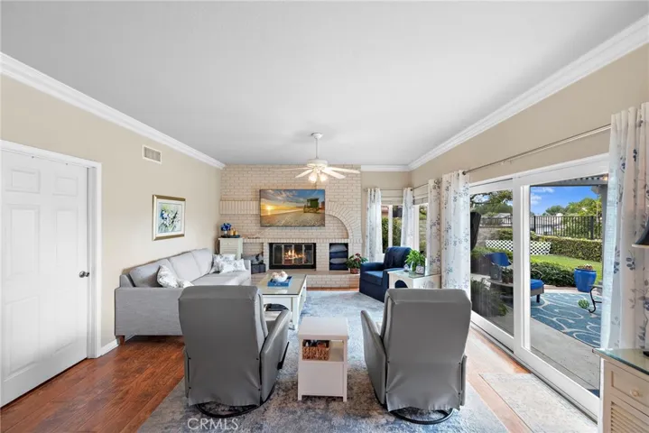 Large family room with the newer installed sliding door, large gas fireplace, more windows giving this room a very light and airy feel.