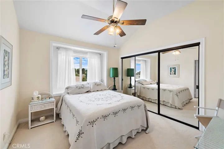 3rd guest bedroom with ample closet space featuring mirrored closet doors.