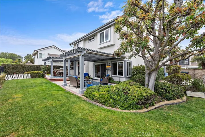 Lovely grassy area to enjoy off the custom patio sitting area and outdoor kitchen
