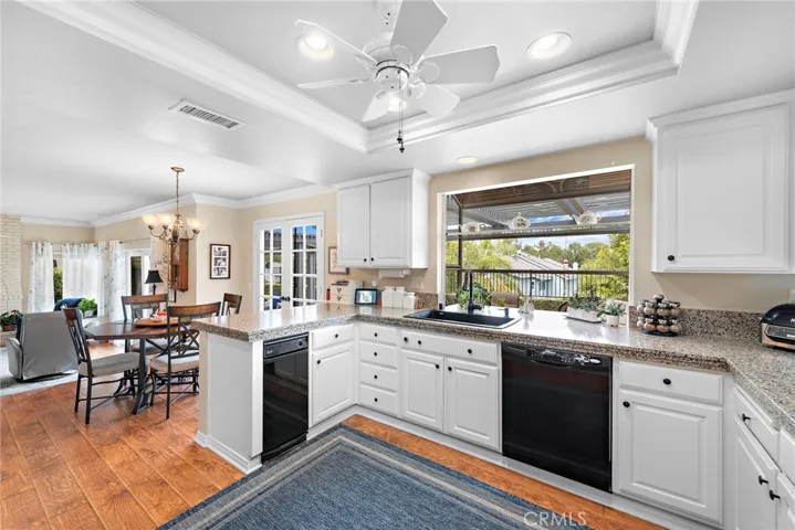 Large kitchen with plentiful counter space and storage. Farm sink at the view thru the greenhouse window. Trash compactor for convenience.