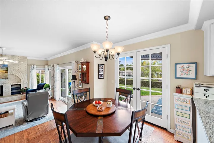 Generous breakfast nook off the kitchen featuring French doors leading to the view private patio. also, open to the large family room.
