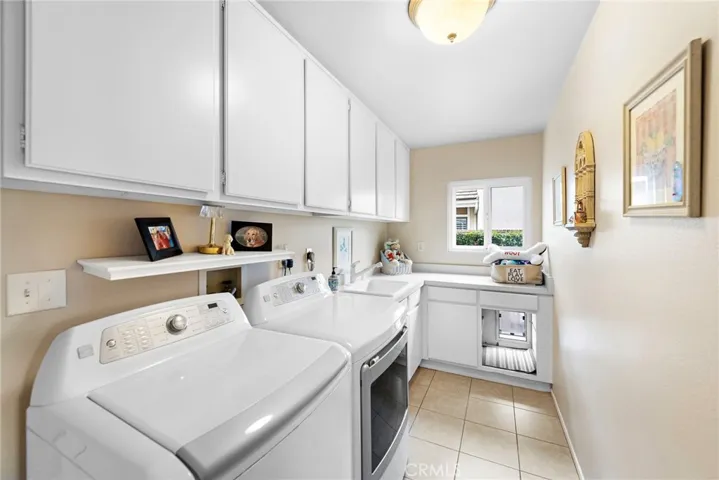 Very large laundry room, with a separate sink, doggy door access to the enclosed dog run, tons of storage and a good size window for a bright and light laundry room.