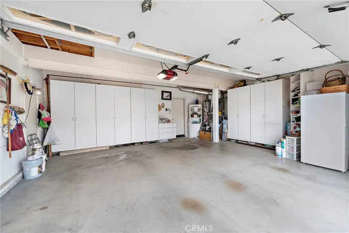 Two car garage a bit over sized with built-in storage and overhead storage.