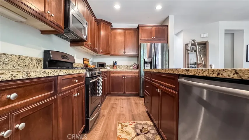 Beautiful kitchen with granite counters, dishwasher, and recessed lighting.