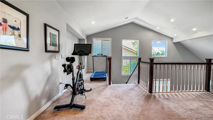 As you walk downstairs this house has natural light with these windows.