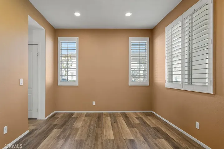 Living room with gas fireplace, custom shutters and LVP flooring