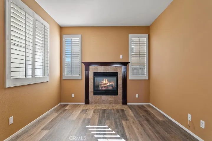 Living room with gas fireplace custom shttters and LVP flooring