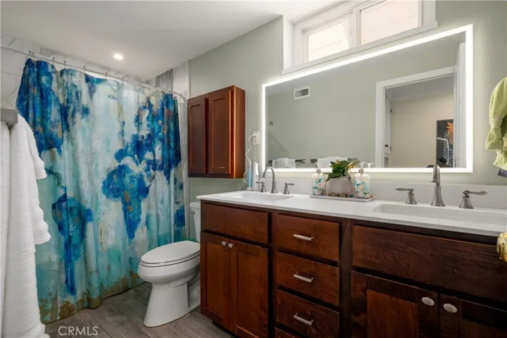 Secondary bedroom with double sink vanity.