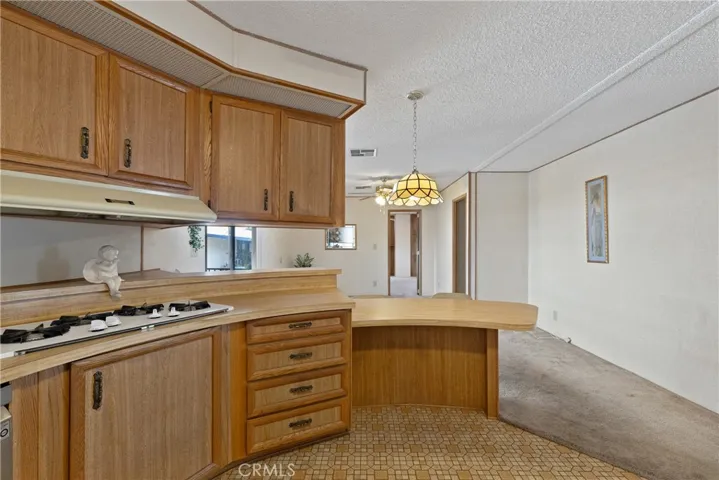 Kitchen breakfast bar opens to family room