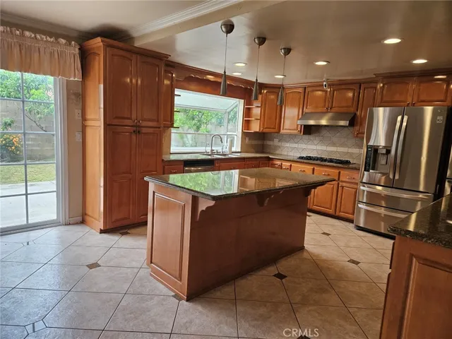 Another View of the kitchen showing an abundant supply of natural sunlight coming in from the Window and the Slider which leads into the backyard