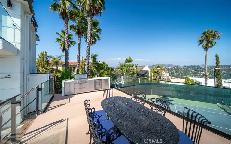 Outdoor dining over tennis, view of Hollywood Sign