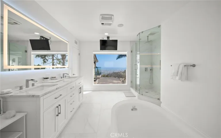 Primary "hers" bathroom with soaking tub, shower and views!