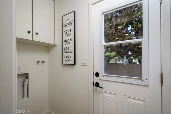 Laundry room with door to back yard.