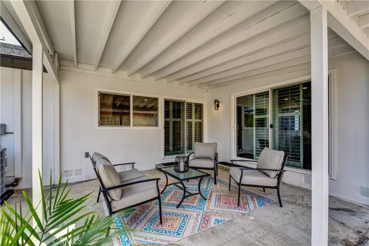 Rear patio with sliders to living room and dining/kitchen.